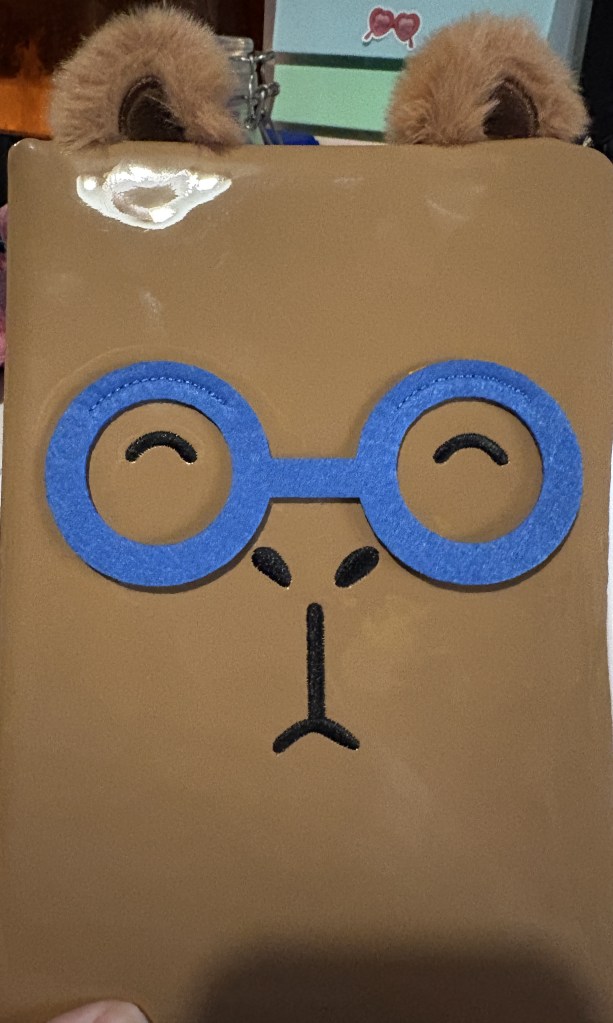 Brown notebook with character face and fluffy ears 